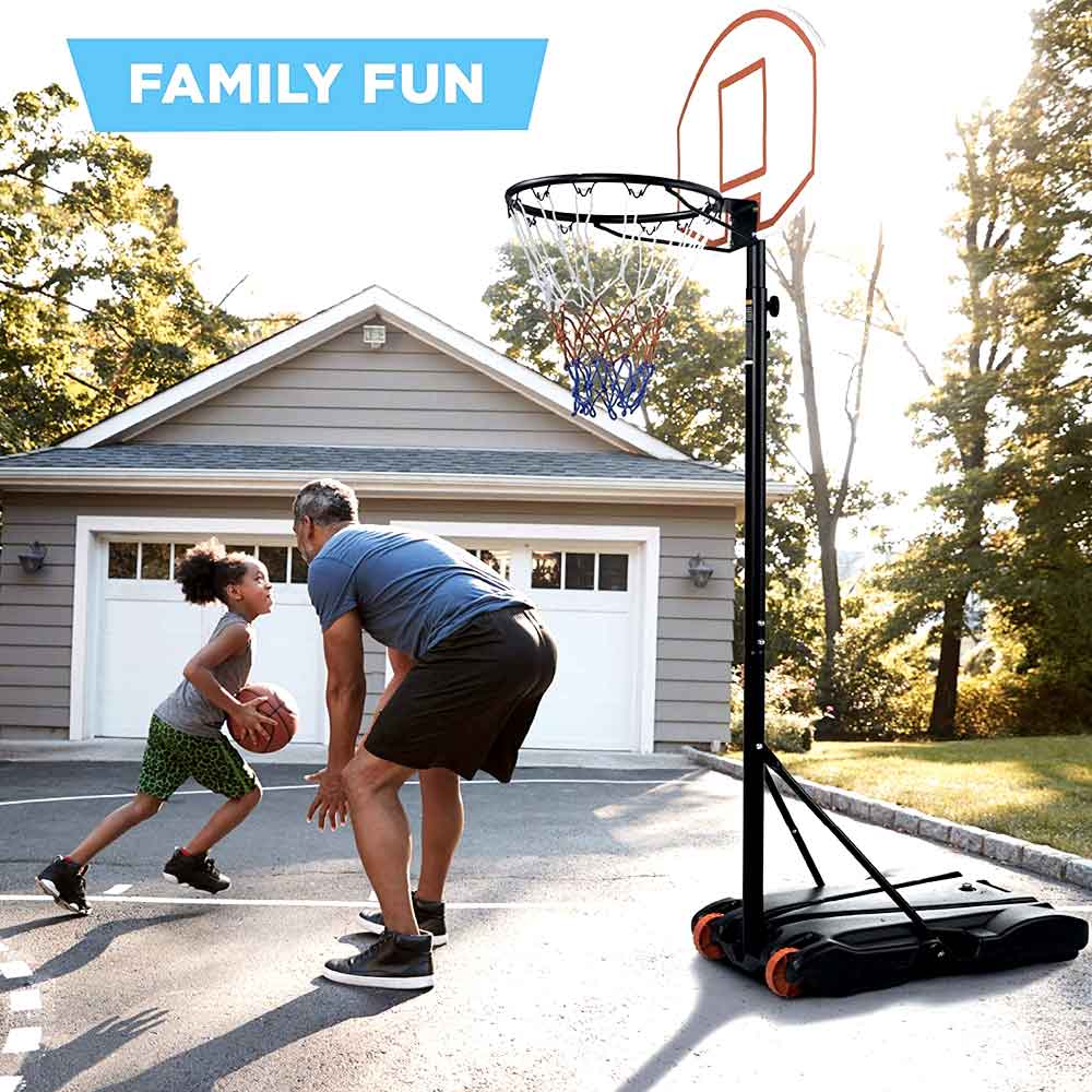 Father and son playing on the driveway hoop