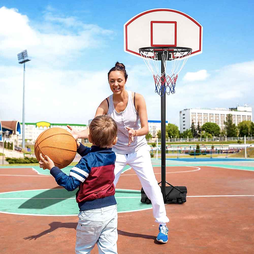 Mother and child shooting hoops on an outdoor court
