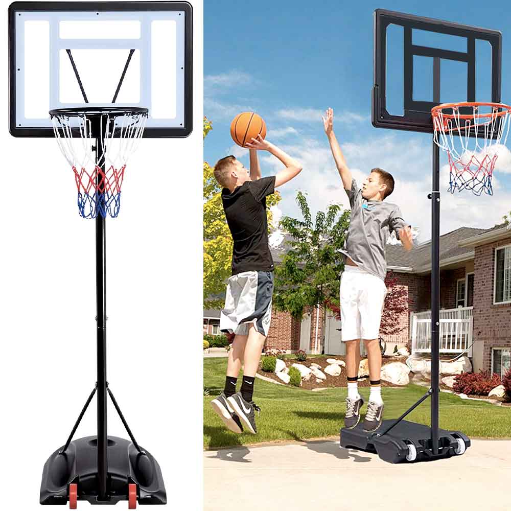 Two boys playing on the youth hoop in a front yard