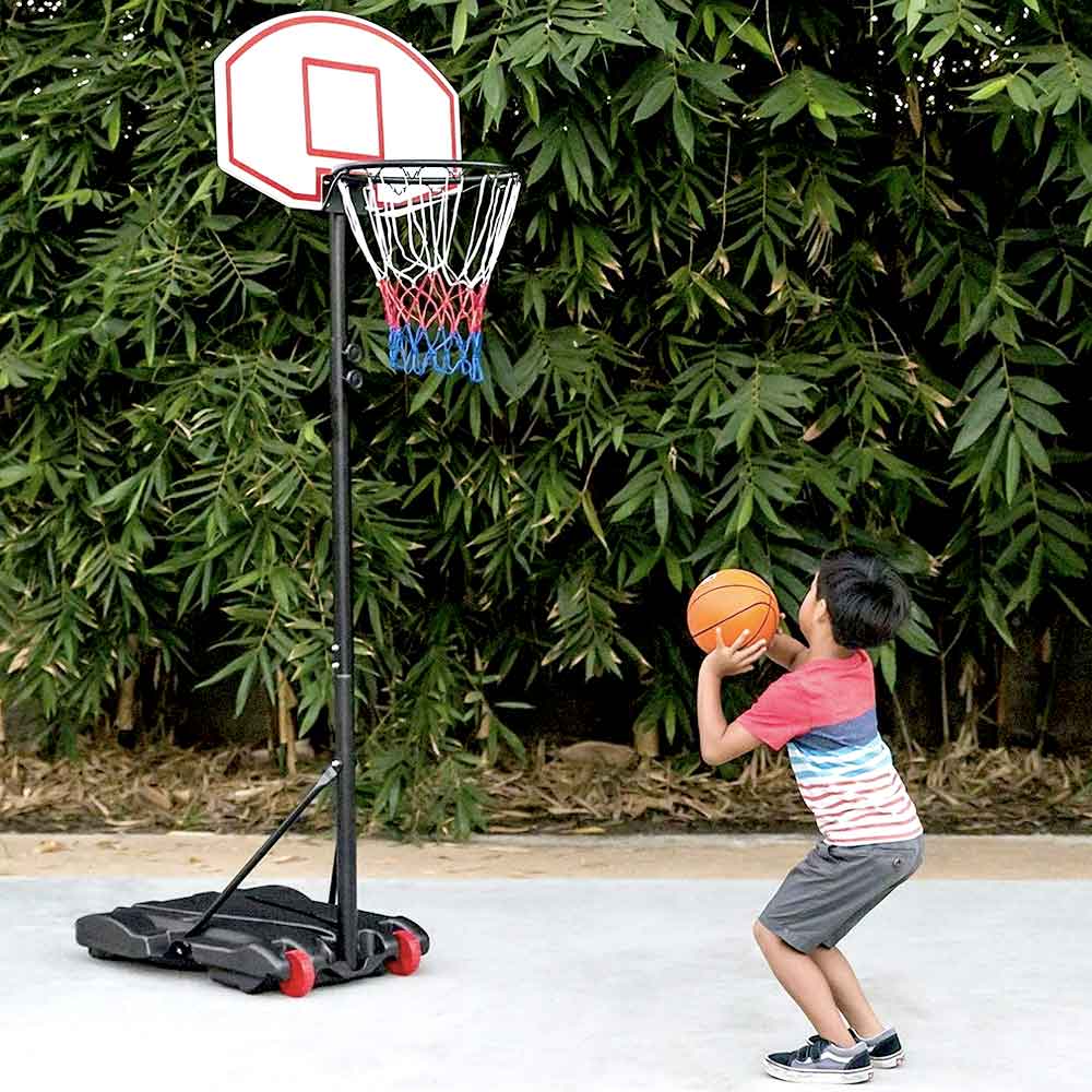 Boy shooting at the kids-size portable hoop outdoors