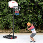 Boy shooting at the kids-size portable hoop outdoors