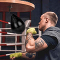 Boxer training on the black speed bag and platform