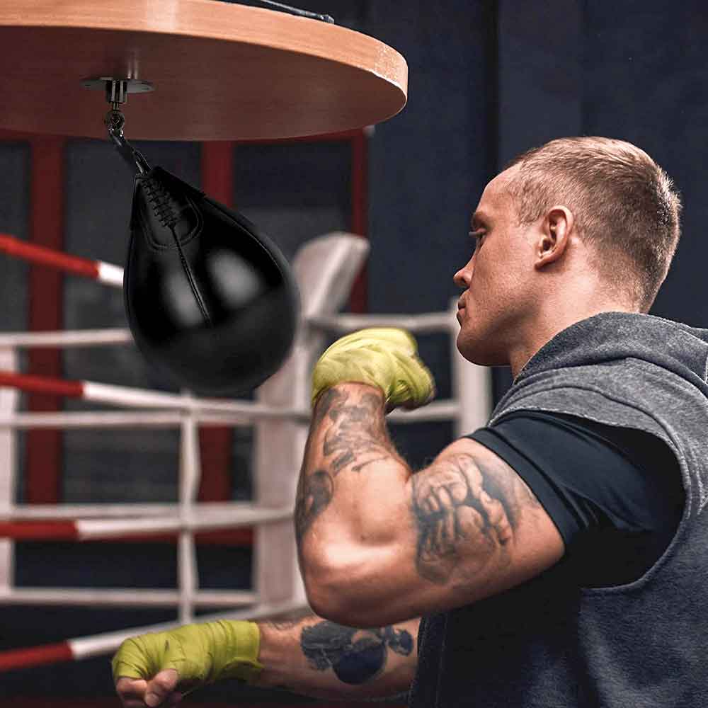 Boxer training on the black speed bag and platform