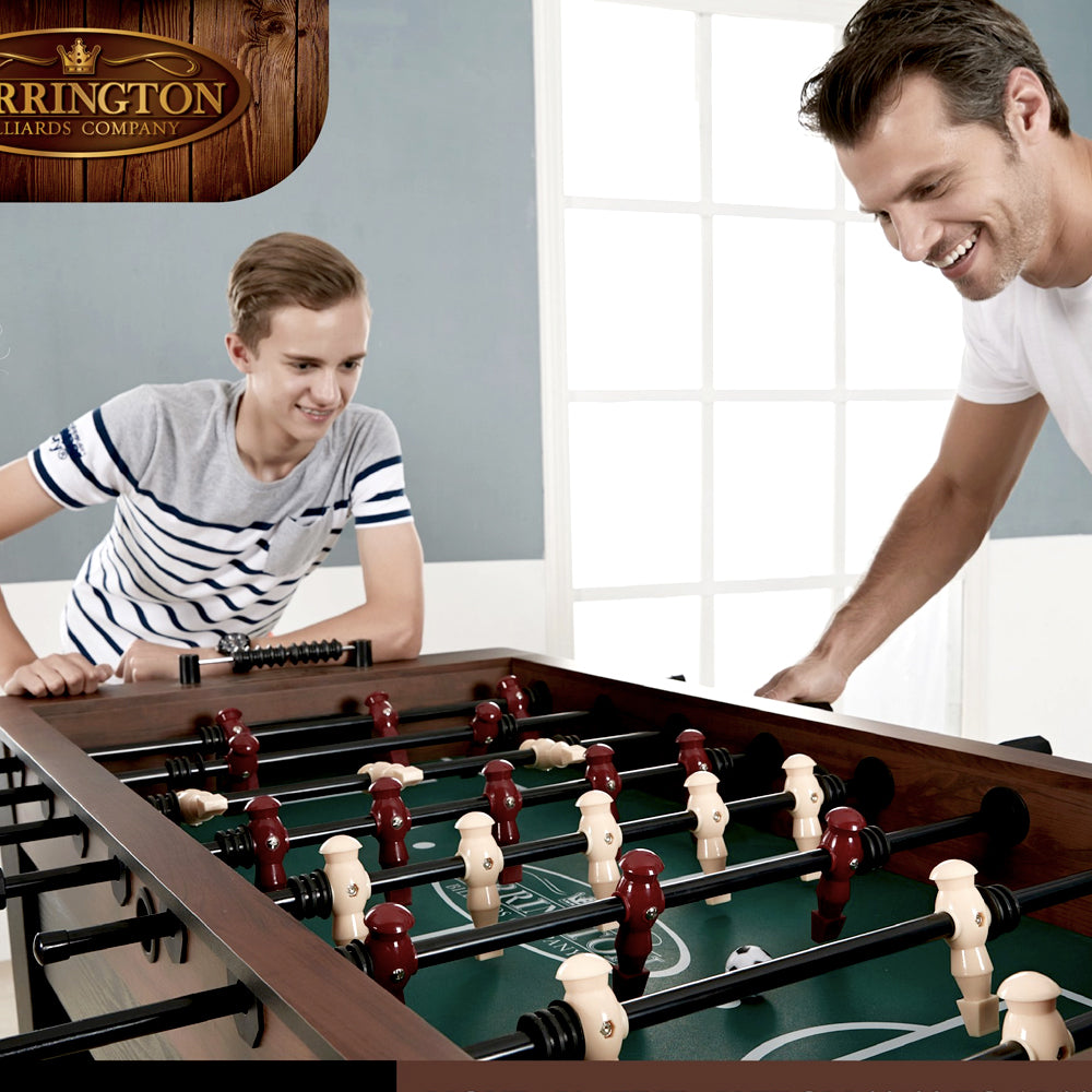 Father and son laughing over a foosball game