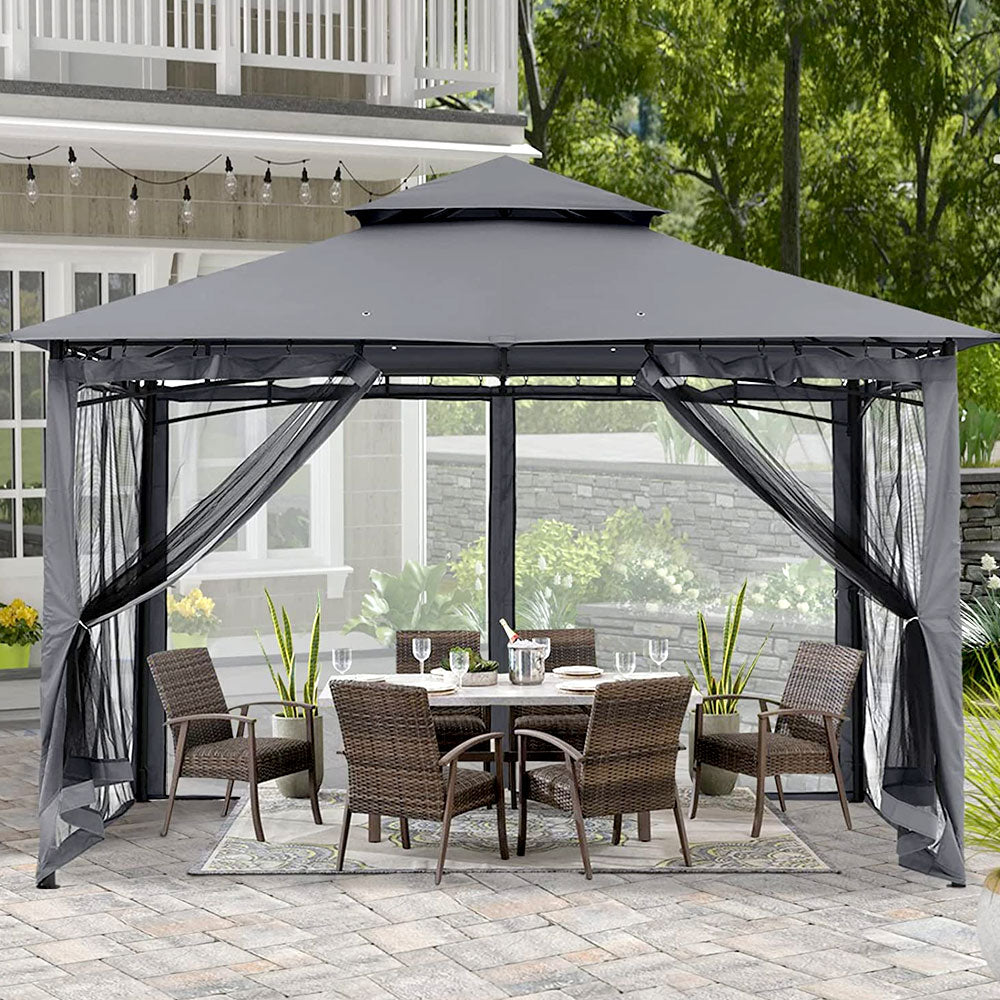 Gray gazebo shading a patio dining table beside a house