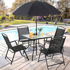 Black patio dining set with umbrella beside a pool