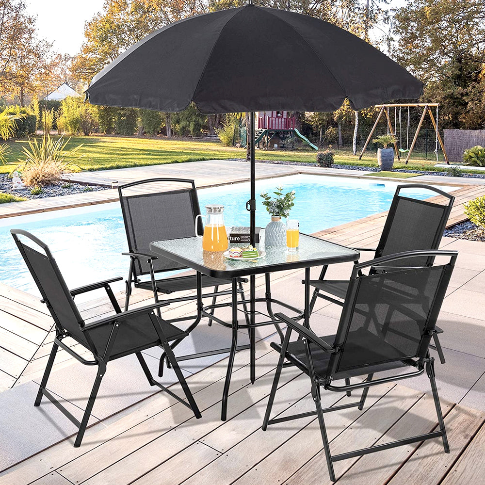 Black patio dining set with umbrella beside a pool