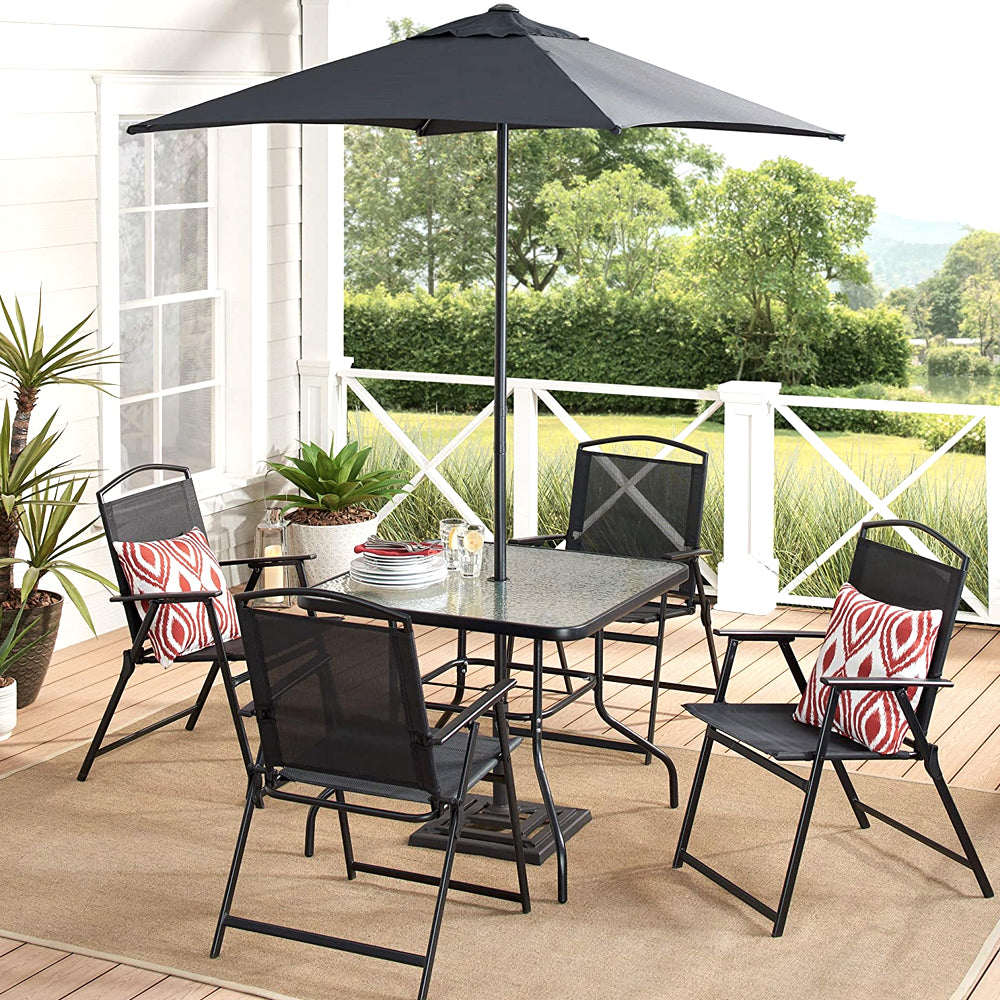 Black patio dining set with umbrella on a porch