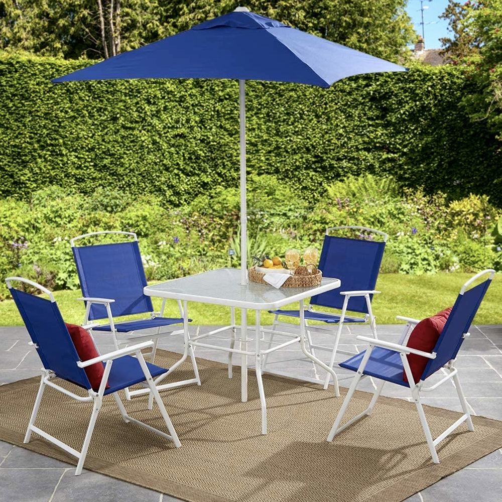 Blue patio dining set with umbrella in a backyard