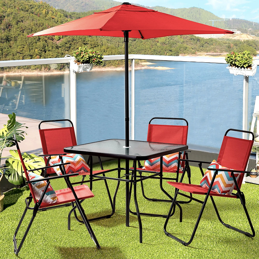 Red patio dining set with umbrella by the water
