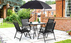 Black dining set and umbrella on a brick-house patio
