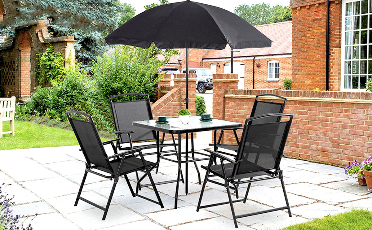 Black dining set and umbrella on a brick-house patio