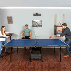 Friends playing ping pong on the blue table in a living room