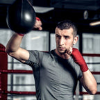 Man training on the speed bag in a boxing gym