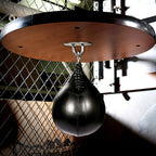Black speed bag hanging from the round platform