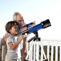 Grandfather and grandchild looking through the blue beginner telescope