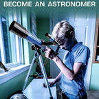Boy looking through the telescope by a window