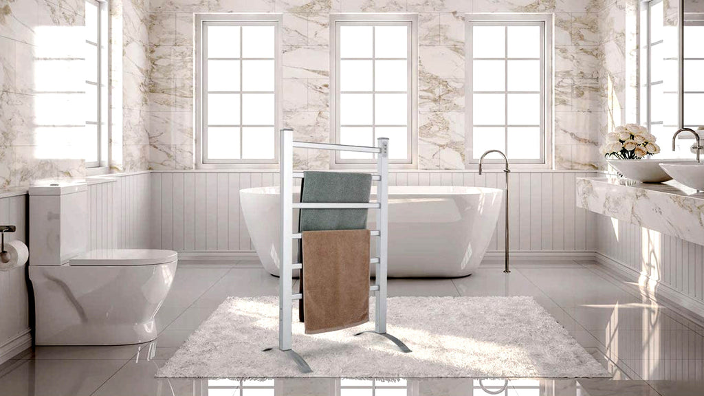 Freestanding towel warmer beside a bathtub in a bright bathroom