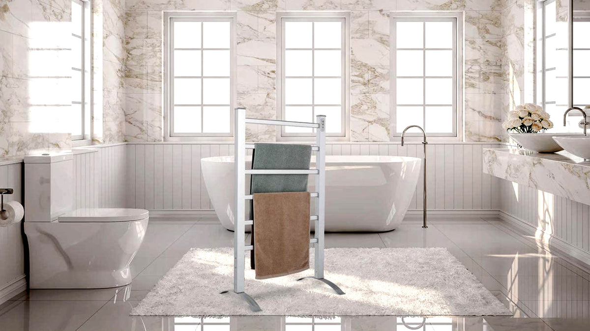 Freestanding towel warmer beside a bathtub in a bright bathroom