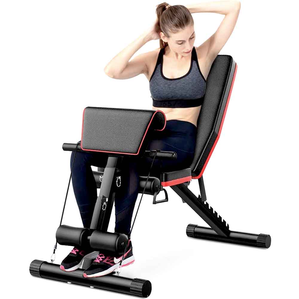 Woman doing seated leg extensions on the workout bench