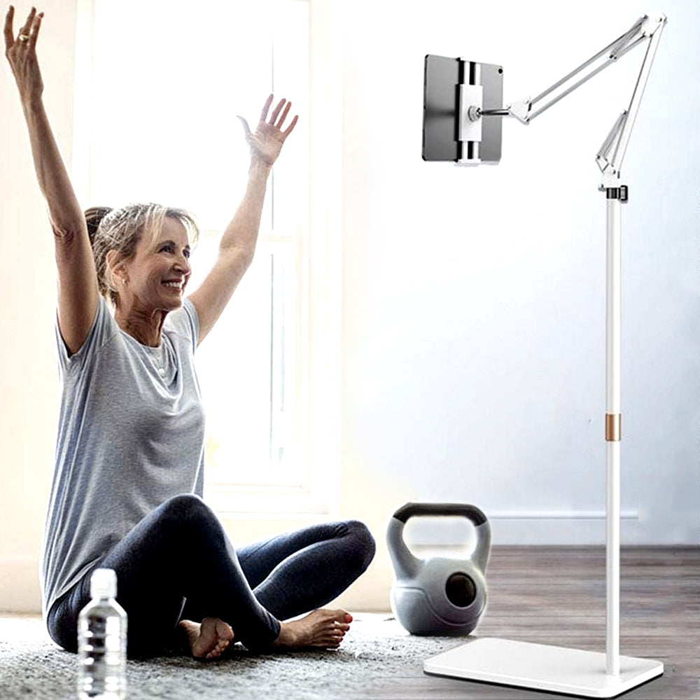 White tablet floor stand holding a tablet during a home workout