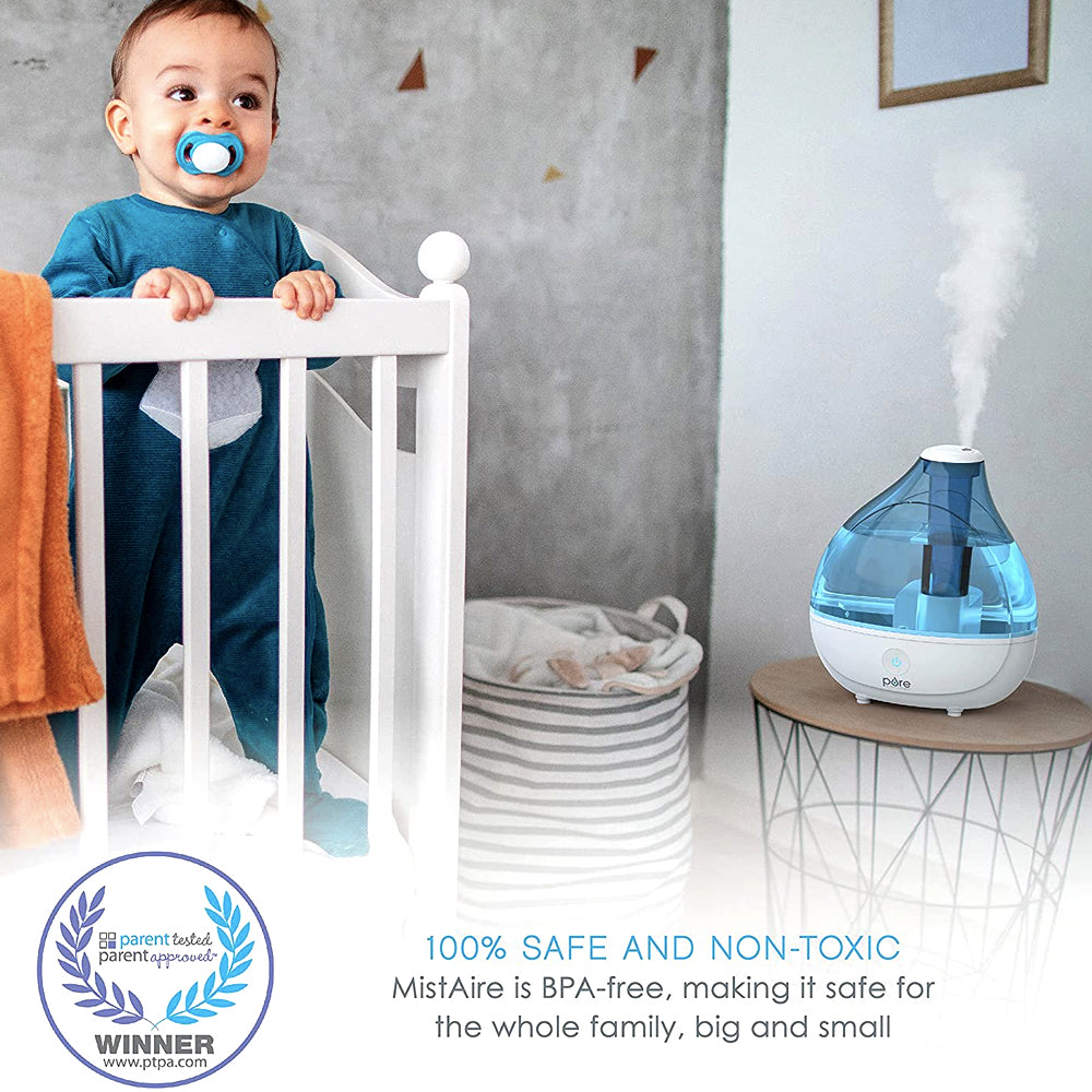 Cool mist humidifier near a baby's crib in a nursery