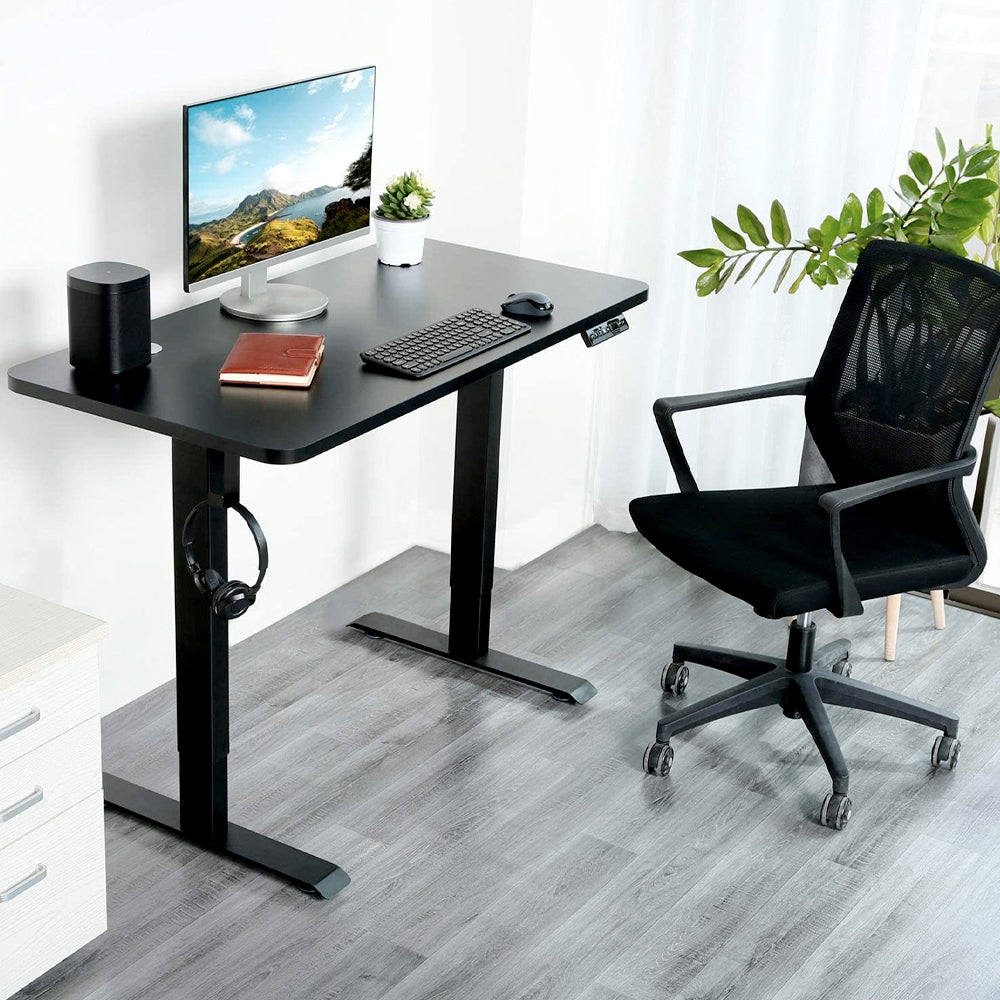 Black standing desk with monitor and office chair