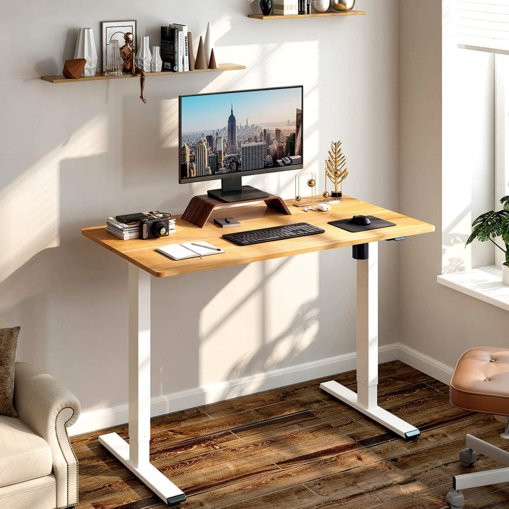 Standing desk with wood-look top and white frame in a home office