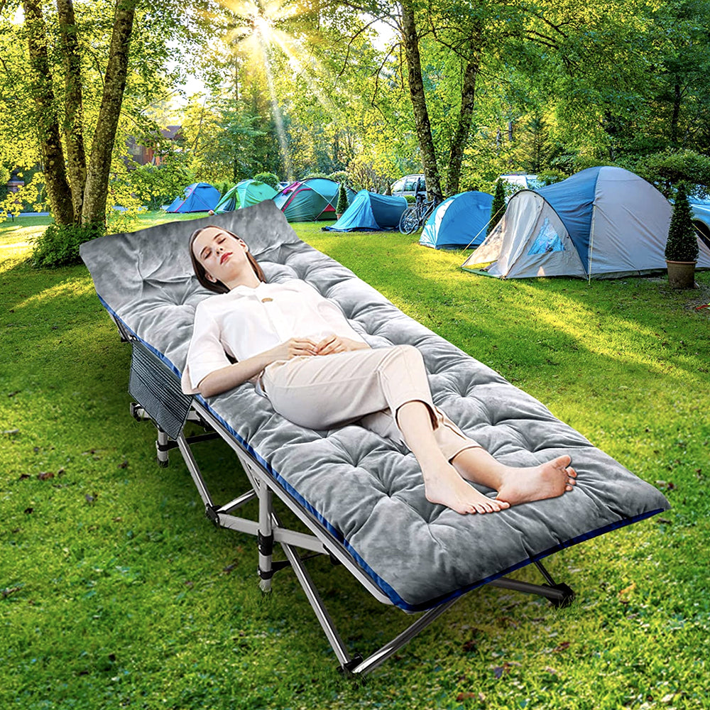 Woman resting on the folding cot at a campsite