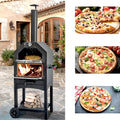 Wood-fired pizza oven on a stone patio, with three baked pizzas