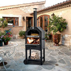 Wood-fired pizza oven on a stone patio with firewood stored below