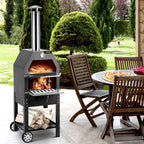 Pizza oven baking beside a patio dining table