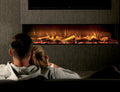 Couple relaxing in front of a wide wall-mounted electric fireplace
