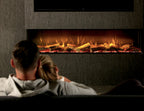 Couple relaxing in front of a wide wall-mounted electric fireplace