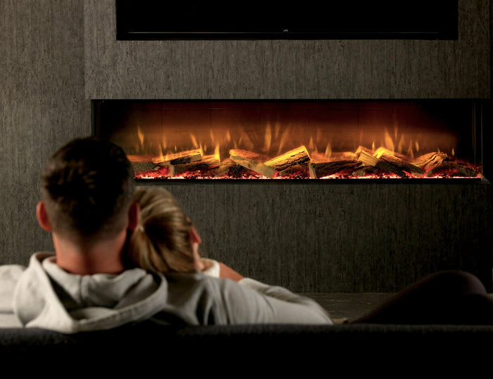 Couple relaxing in front of a wide wall-mounted electric fireplace