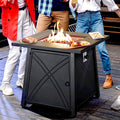 Friends gathered around the square propane fire pit table on a deck