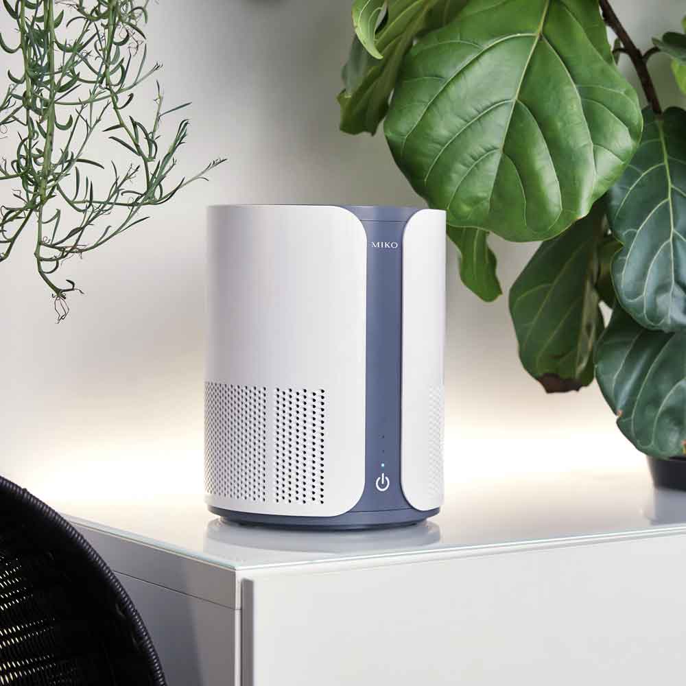 White and gray air purifier on a side table