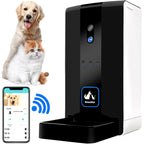 Black and white automatic pet feeder with its phone app, beside a dog and cat